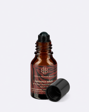 Brown glass bottle with black cap on a white background