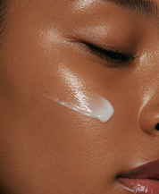 Close-up of a person applying cream to their face