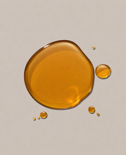 Amber-colored liquid droplets on a beige background